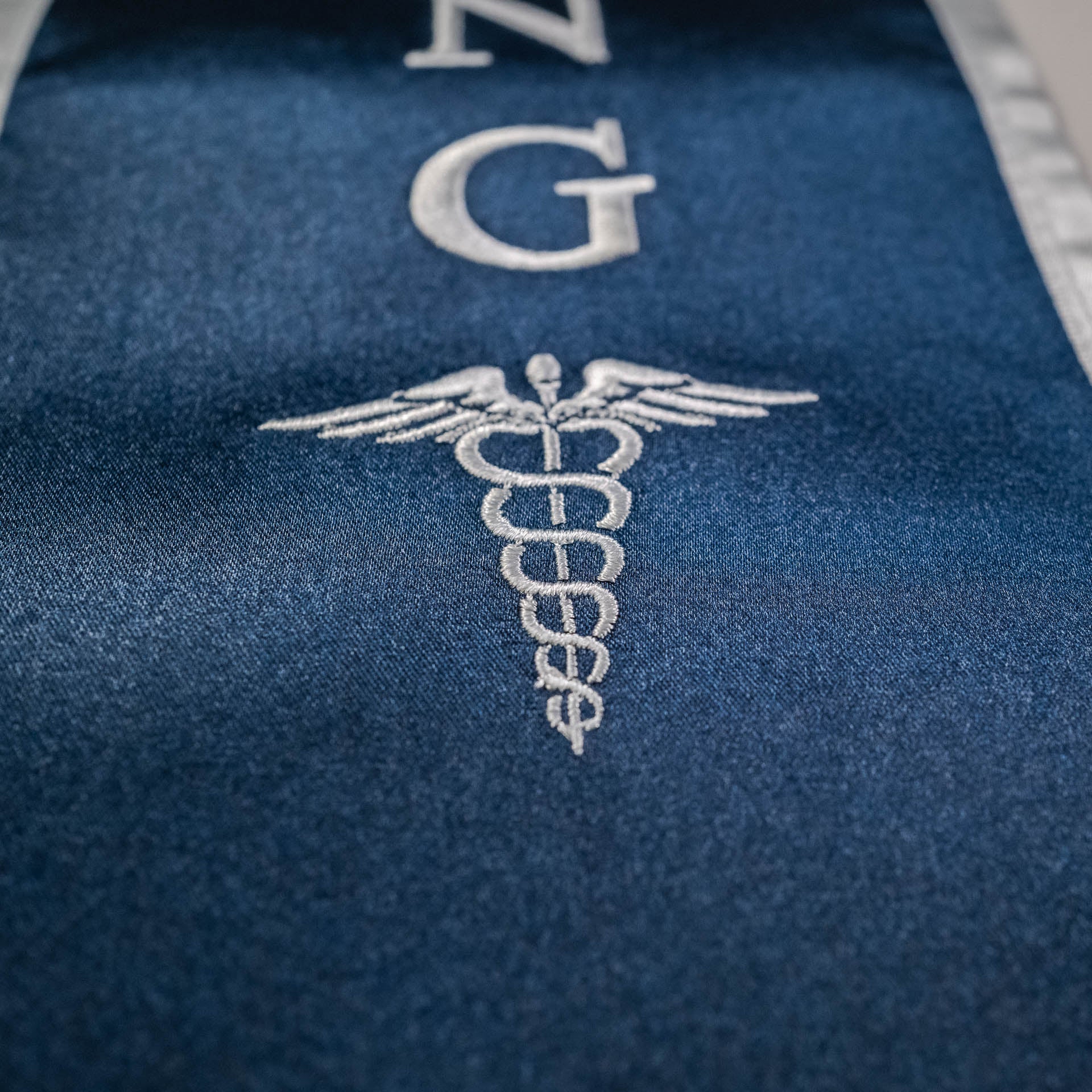 Custom graduation stole with sharp embroidered logo on luxury satin