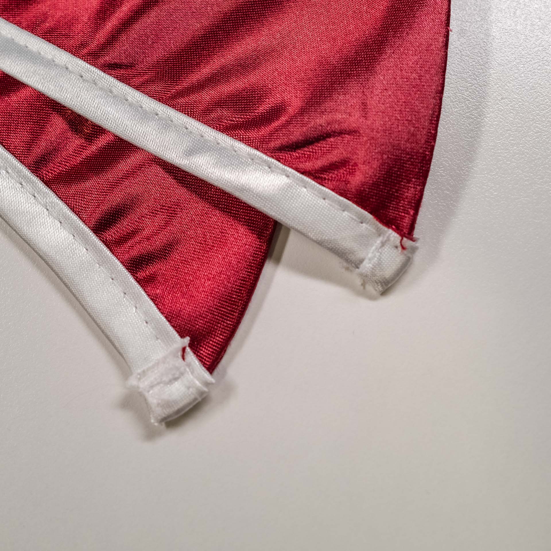 Competitor graduation stole tip showing thin fabric and loose stitching